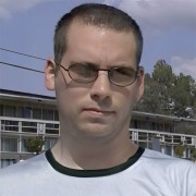 Man with close-cropped dark hair wearing sunglasses